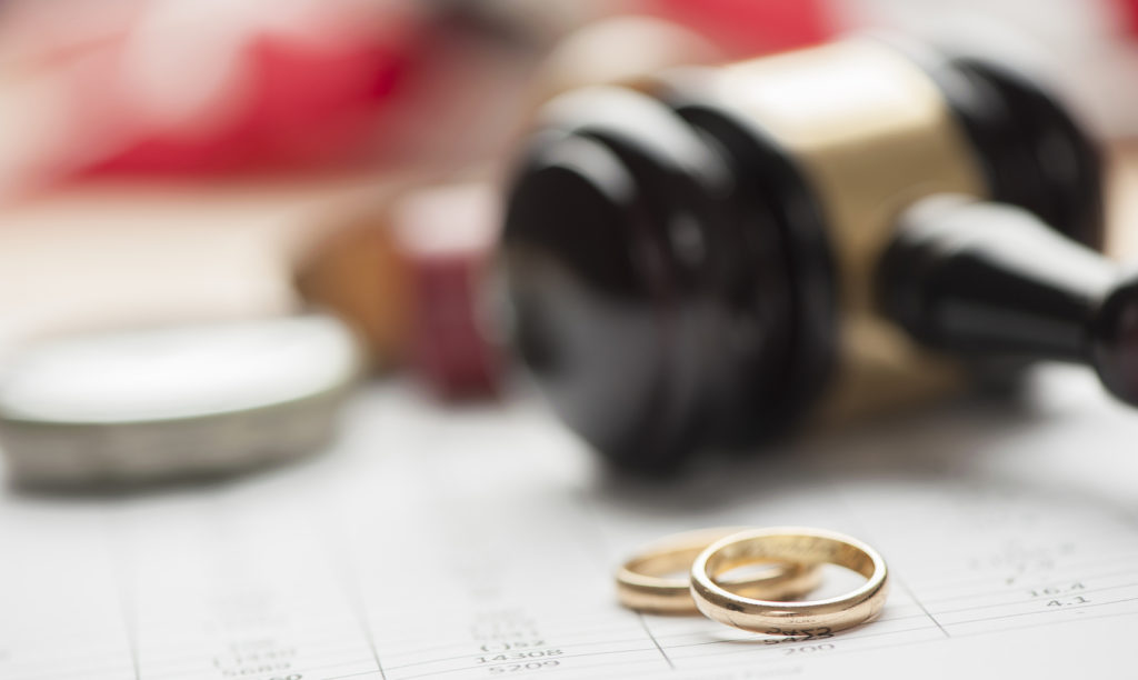 Gavel and wedding rings for divorce concept